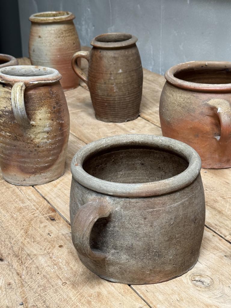 A Collection of 12 Stoneware Pots